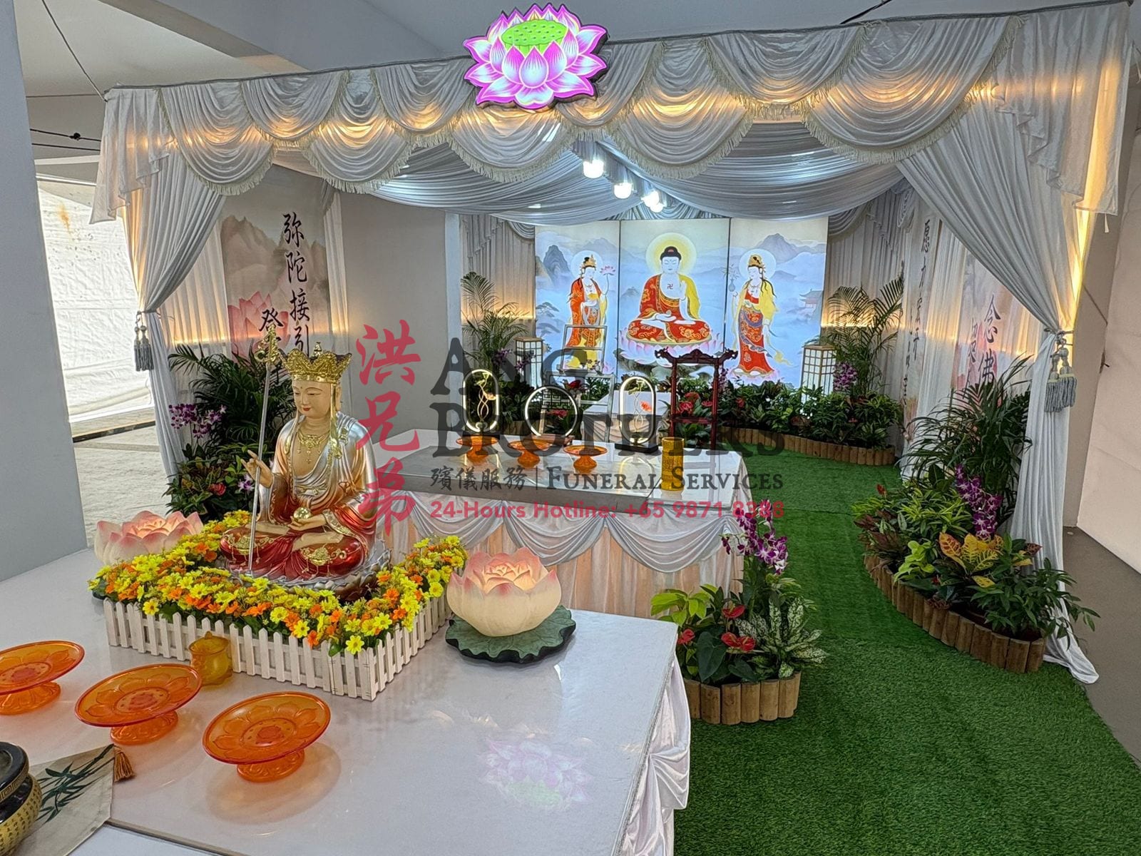 An elaborate Buddhist altar with a gold Guanyin and the three Buddhas