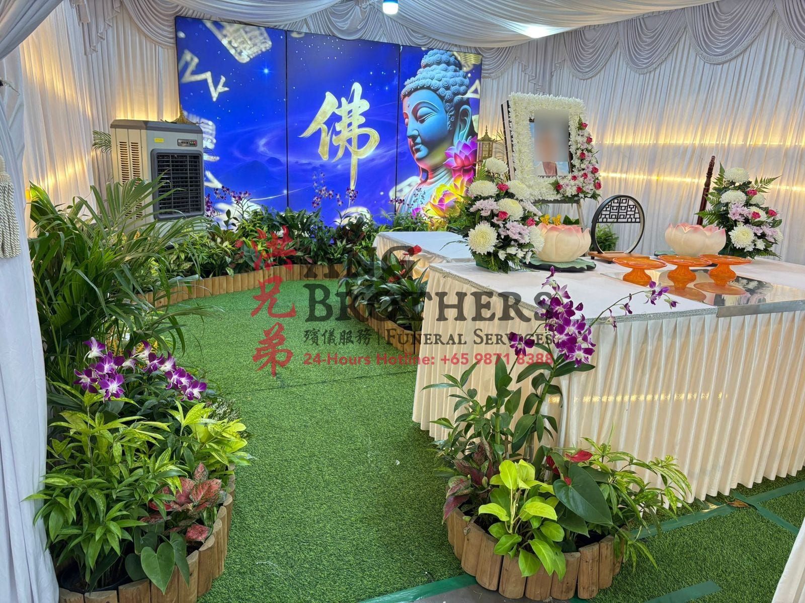 A garden Buddhist altar beneath a glowing Buddha screen