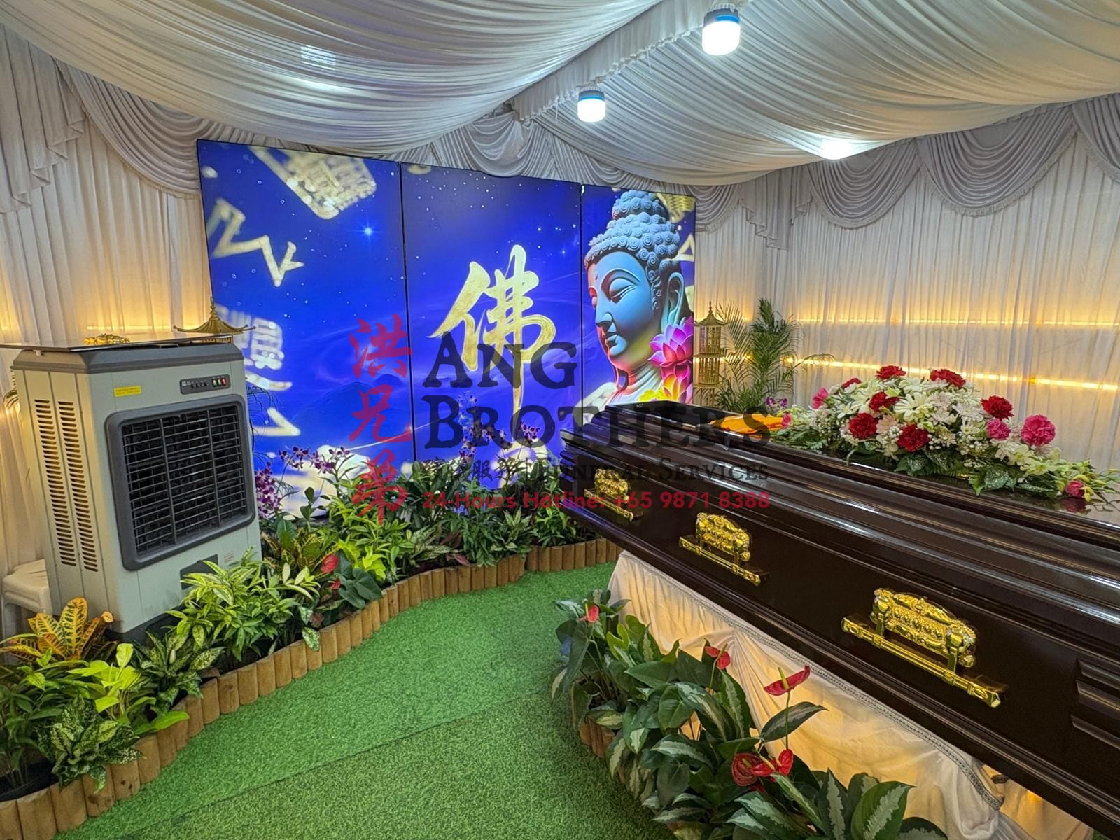 Buddhist funeral setup with a Buddha backdrop by Ang Brothers