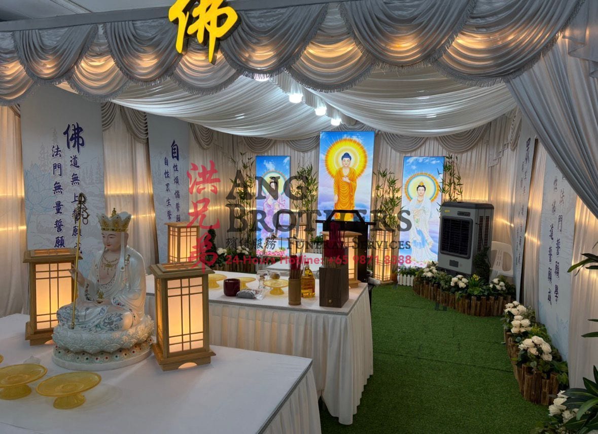 Buddhist funeral altar with deity figures and scripture banners by Ang Brothers