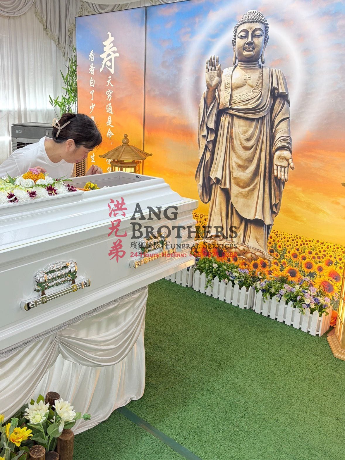 A family member at the last viewing beside the casket before the cortège leaves