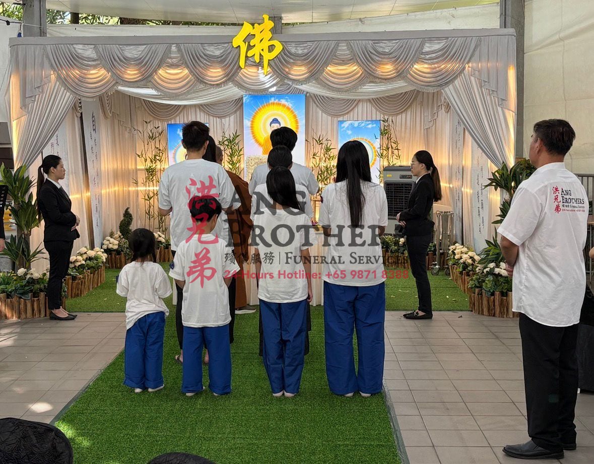 A family gathered before a Buddhist wake altar