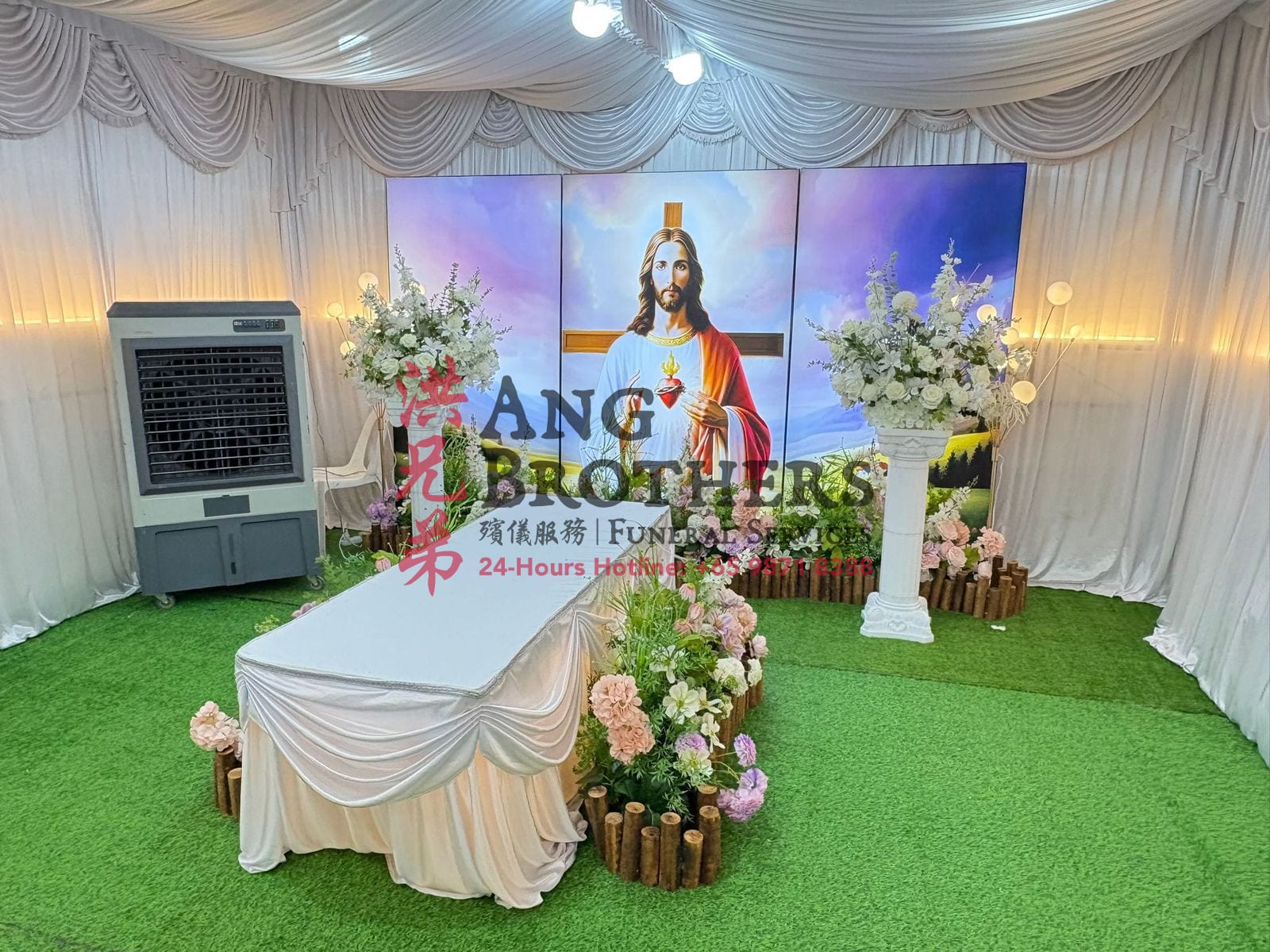 Sacred Heart setup with a white casket