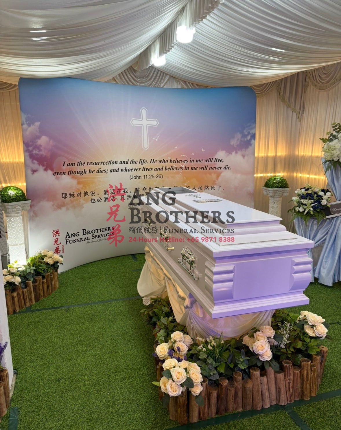 A Christian and Catholic funeral setup with the cross and the resurrection promise by Ang Brothers