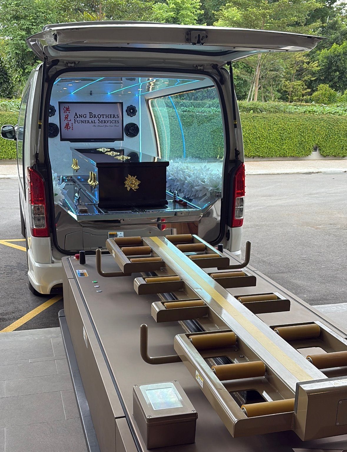 A casket carried in the Ang Brothers glass hearse for a direct cremation