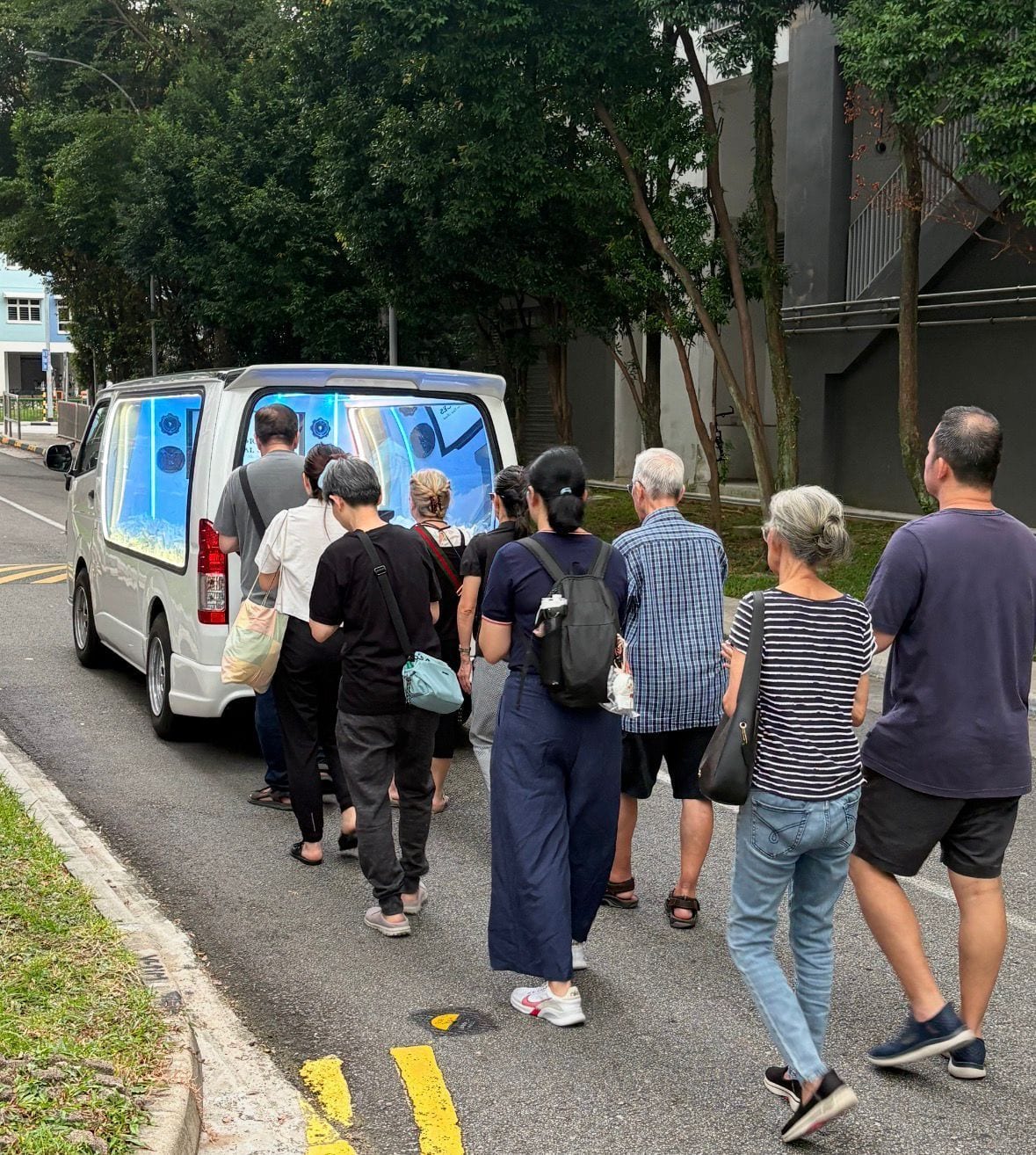 A casket carried in the Ang Brothers own glass hearse
