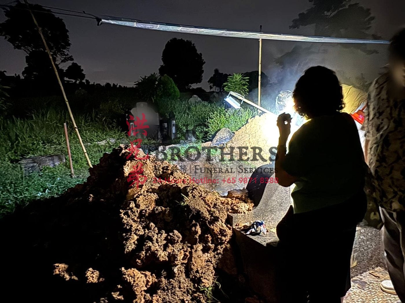 Grave exhumation in Singapore carried out before sunrise by Ang Brothers