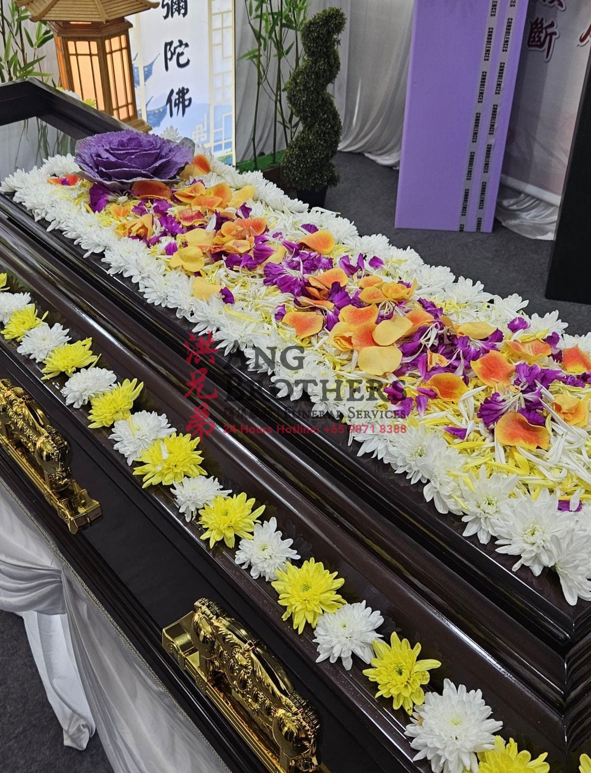 Fresh flowers laid along the lid of a casket