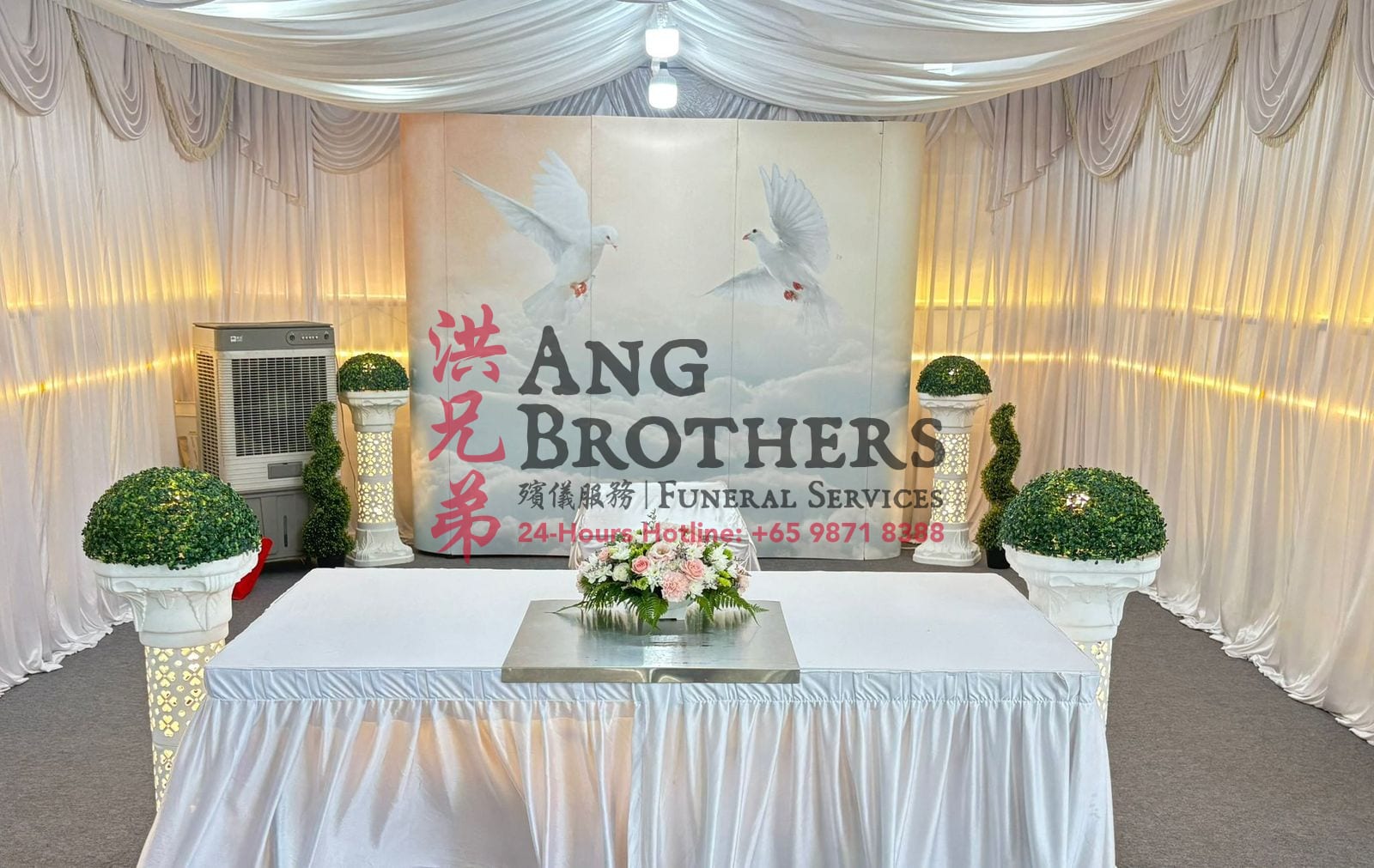 A white altar with flowers and a doves in the clouds backdrop