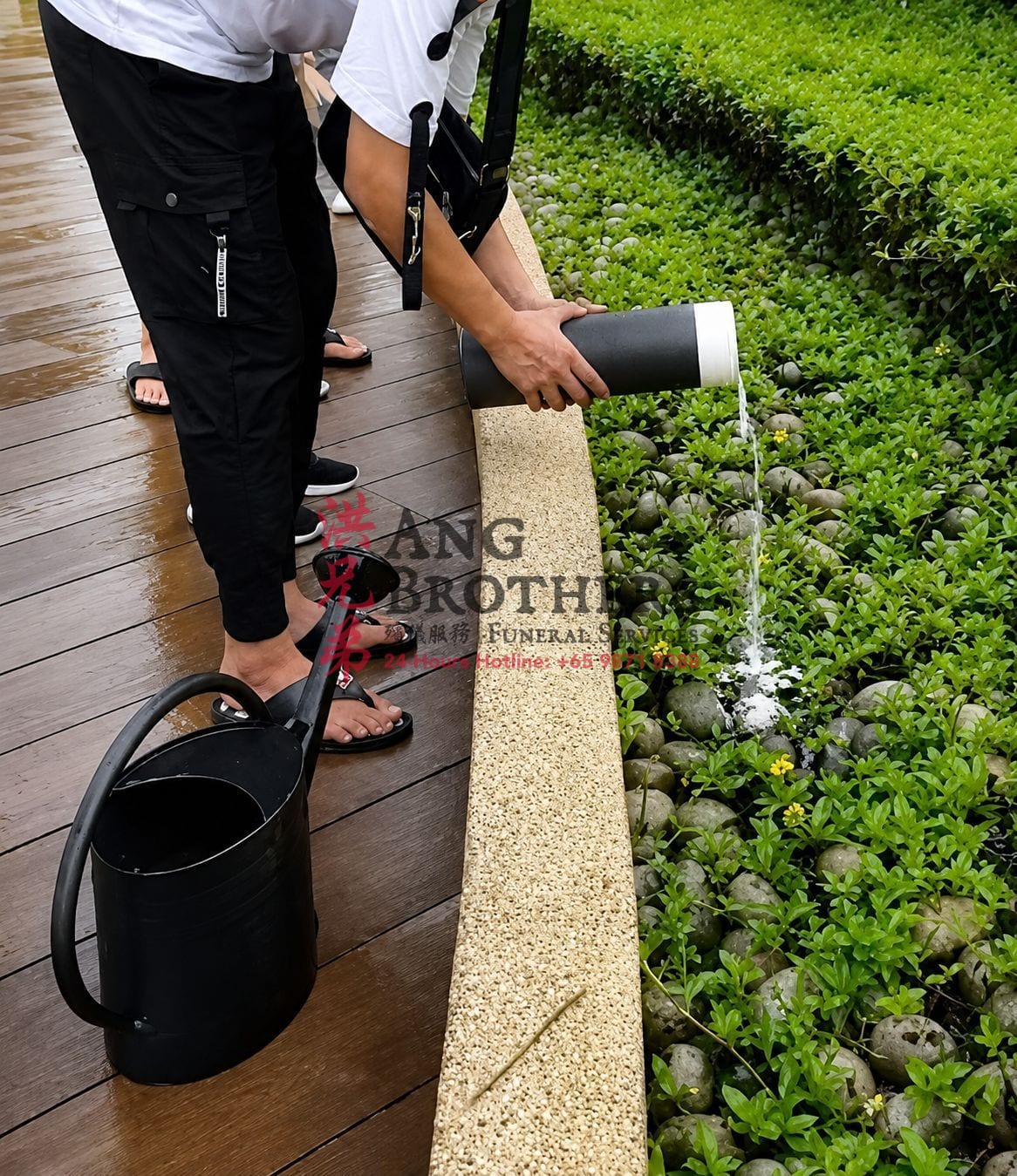 Ashes poured from an urn into the garden bed and eased in with water