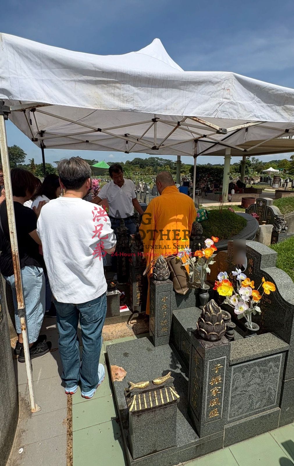 A graveside prayer at the final farewell, led with care by Ang Brothers
