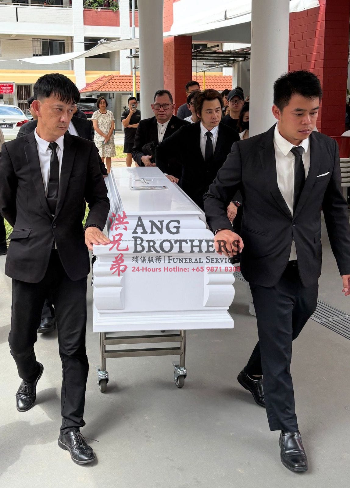 Pallbearers carrying a casket at the send off