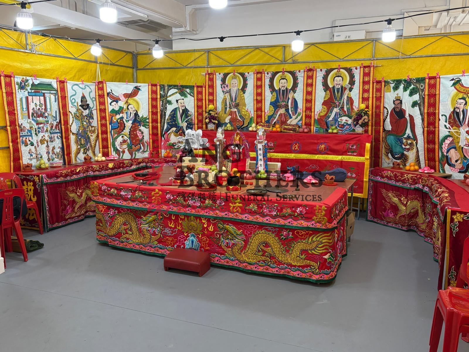 Taoist altar with deity scroll banners and offerings by Ang Brothers