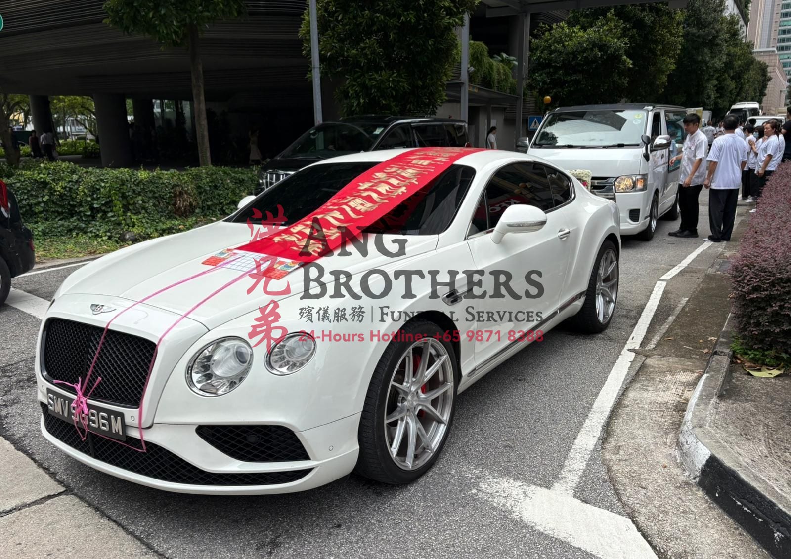 A white Bentley leading a Hokkien Taoist funeral send off by Ang Brothers